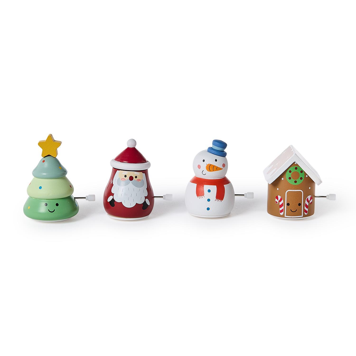 Four wooden wind-up toys: a Christmas tree, Santa Claus, a snowman, and a gingerbread house.