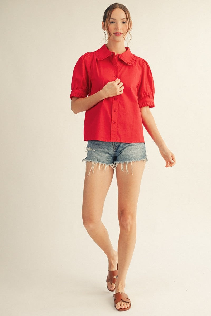 Solid white women's button-down top with Peter Pan collar, short puff sleeves, and ruffled edges.