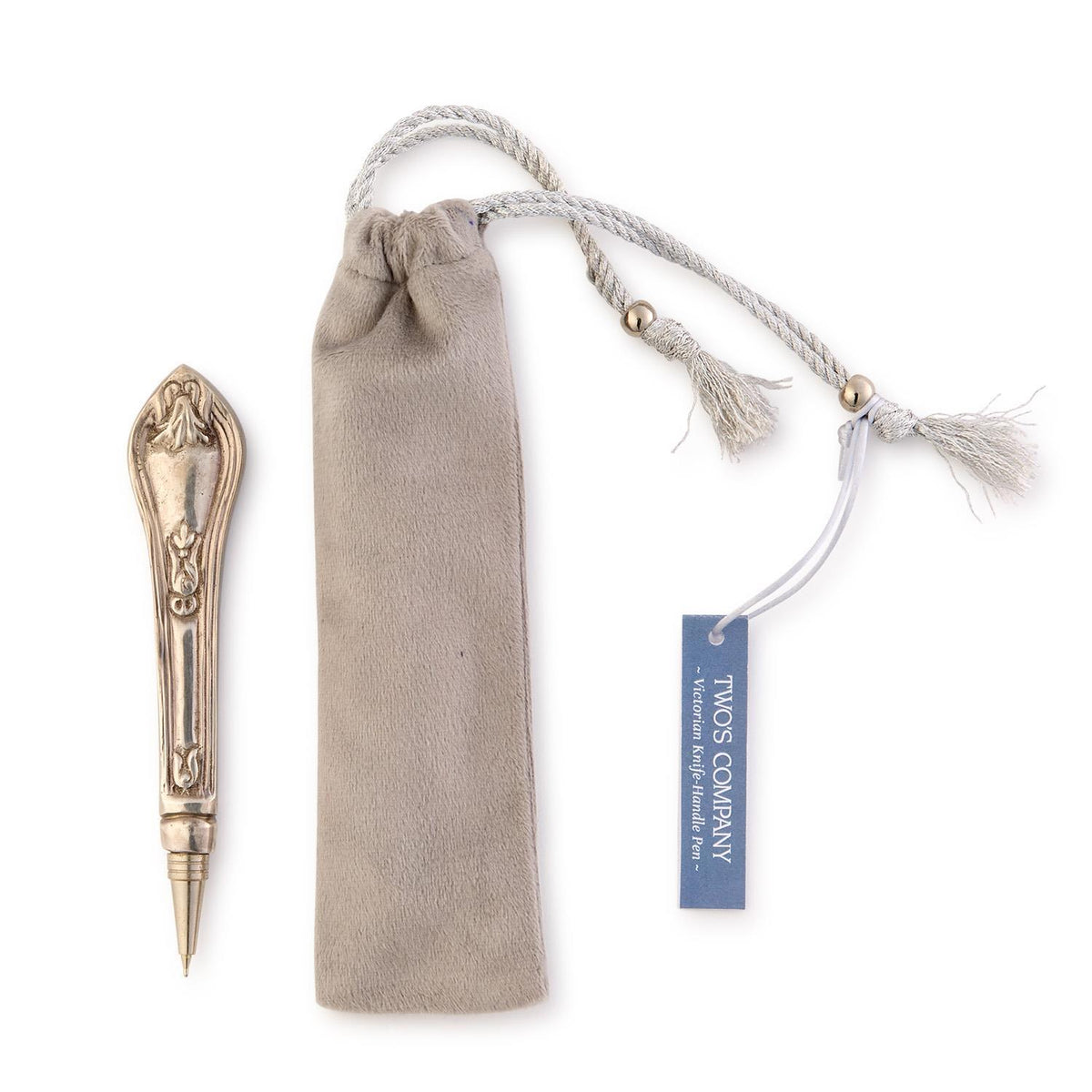 Victorian knife handle pen in silver-plated brass next to a grey velvet gift pouch with a blue tag.