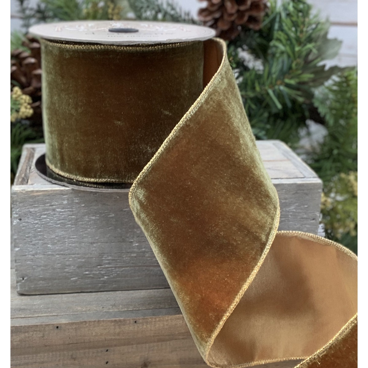 4 inch wide olive green vintage French velvet ribbon with gold wired edges on a wooden crate.