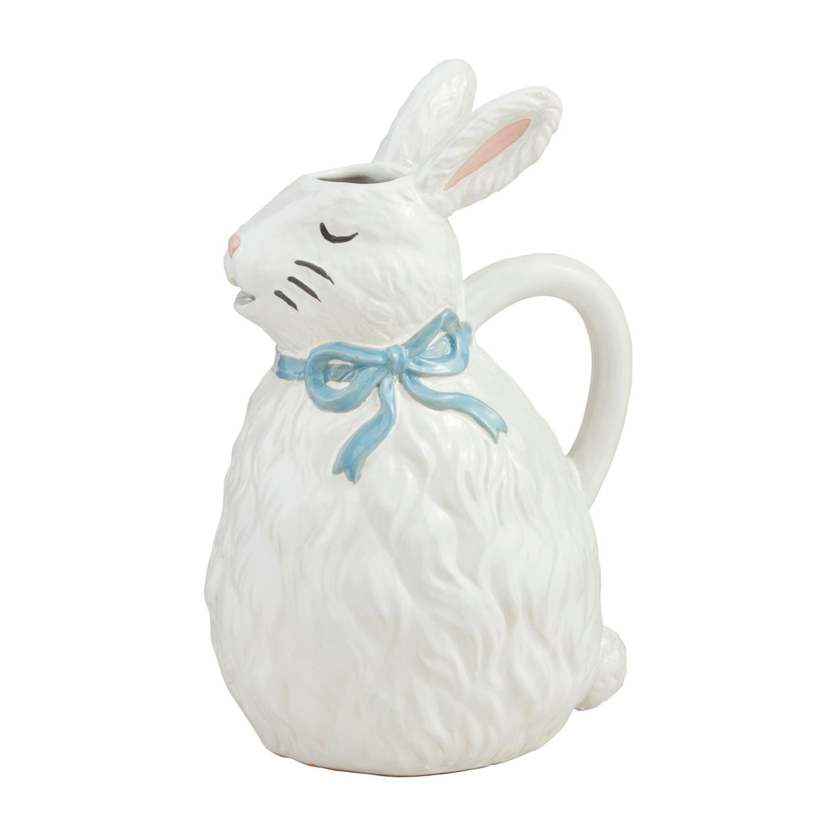 White stoneware bunny pitcher with a blue bow, textured fur details, and a curved handle.