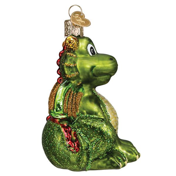 Green glass dragon ornament with gold glitter wings and red scales sitting on a white background.