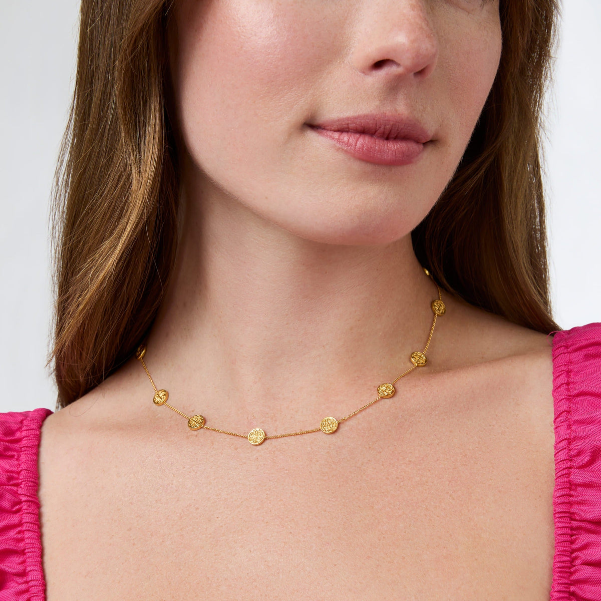 Nine delicate gold coin stations on a fine adjustable chain necklace.