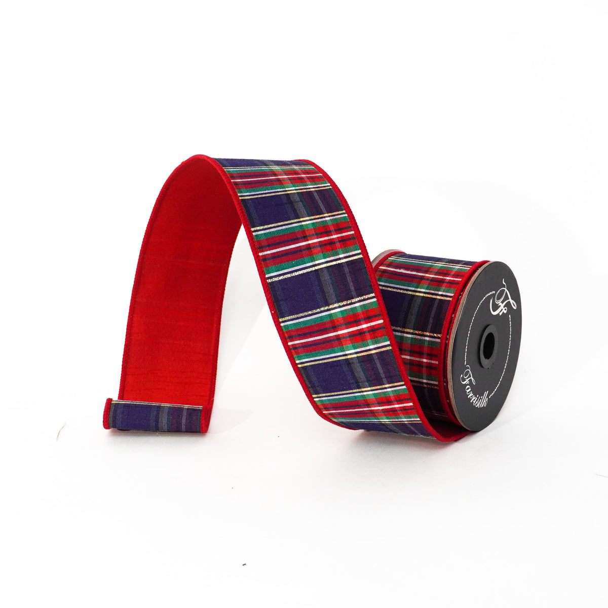 Christmas plaid ribbon with a red velvet backing, unrolled from a spool on a white background.