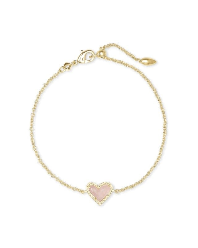 Ari Heart gold chain bracelet featuring a rose quartz pendant on an adjustable yellow brass link.