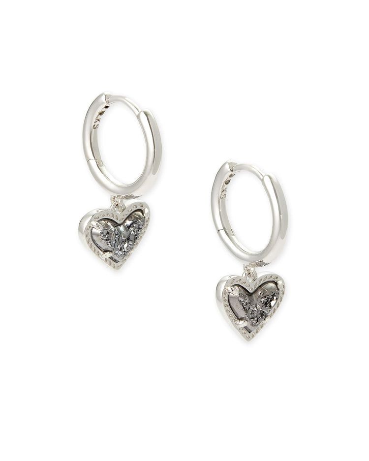 Silver huggie earrings featuring a platinum drusy heart charm with an asymmetrical hinge closure.