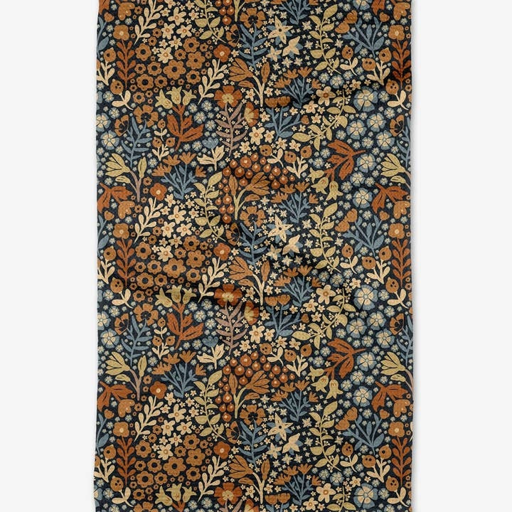 Fall-themed tea towel with waffle weave texture in warm autumn colors.