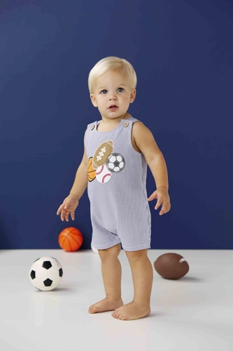 Blue and white striped Jon Jon swim trunks with sport-themed appliques including a football, soccer ball, basketball, and baseball.