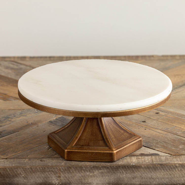 Square metal riser with a white marble top measuring 10 inches wide.