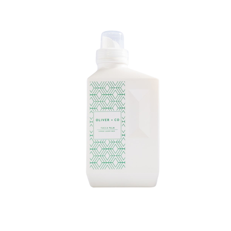 White bottle of Oliver + Co Supreme Laundry Wash in Yucca Palm scent with green geometric pattern.