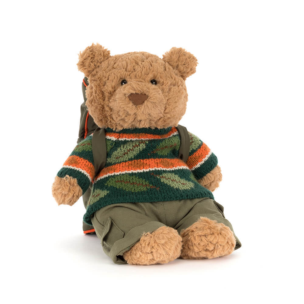 Bartholomew Bear plush toy wearing a green leaf-patterned sweater, cargo pants, and a backpack.