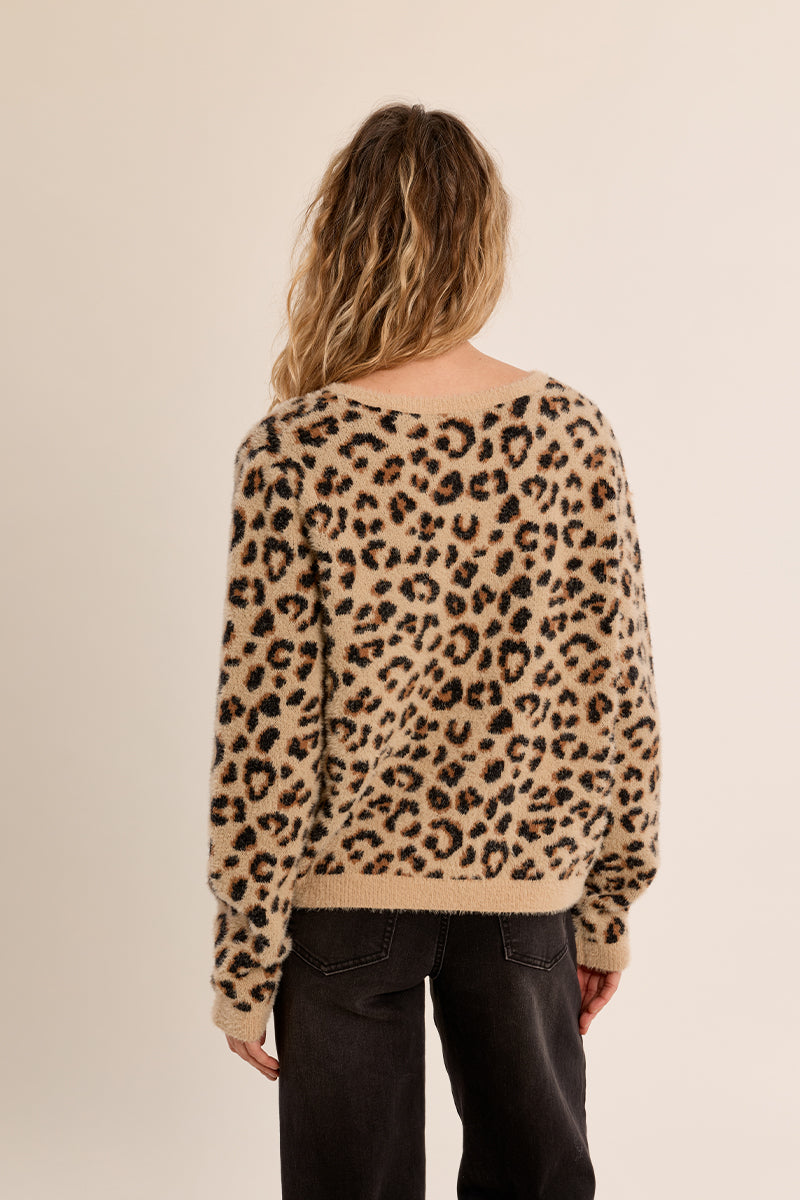 Back view of a woman wearing the Cathy Ladies Knitted Sweater in a fuzzy leopard print.
