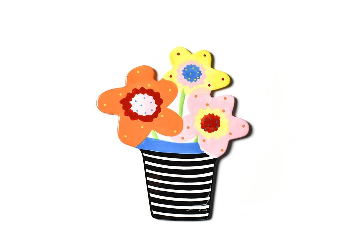 Ceramic wall attachment with floral pattern in cheerful colors featuring a hook-and-loop fastener.