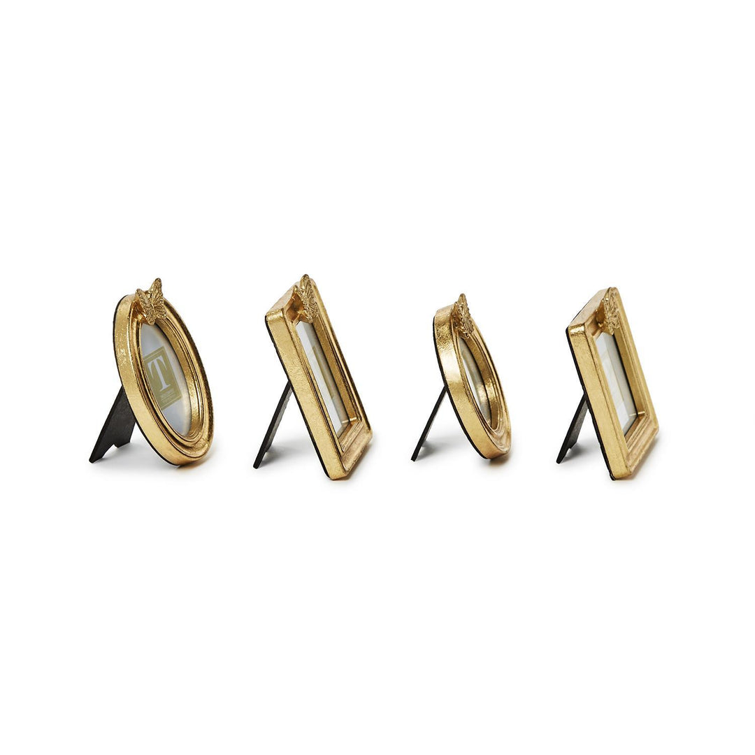 Four small gold leaf finish photo frames in oval and rectangular shapes with butterfly accents.