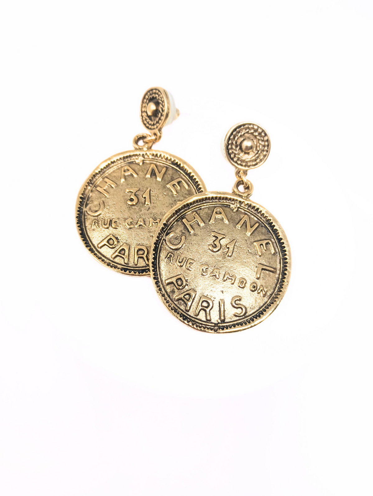 Gold dangle earrings featuring a Chanel-style coin pendant with pierced ear hooks.