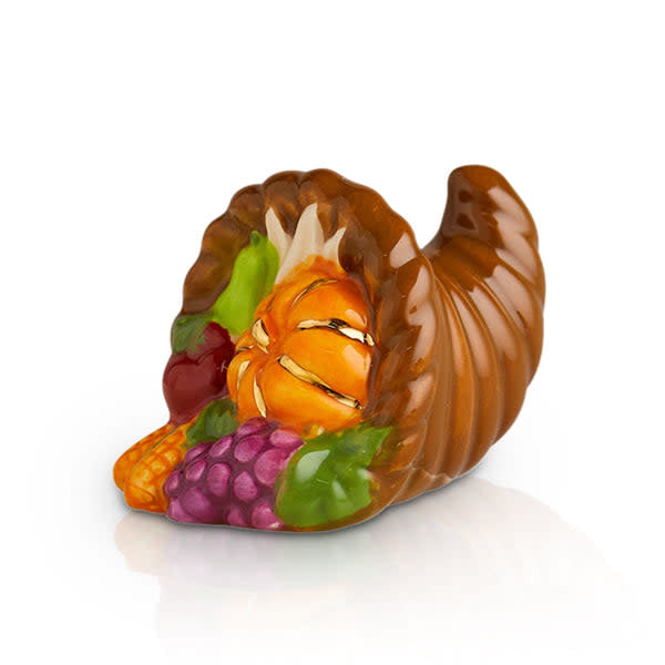 Ceramic cornucopia figurine featuring a pumpkin, grapes, and autumn produce in a brown horn shape.