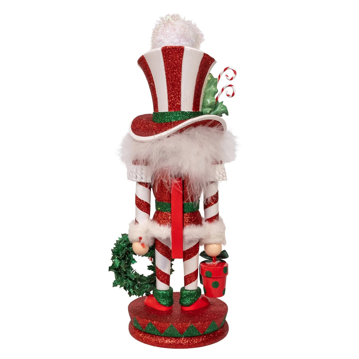 Back view of a 15-inch Hollywood Mr. Christmas Nutcracker with red and white candy cane stripes.