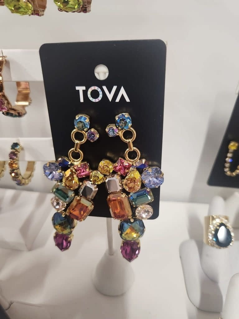 Aviva earrings featuring a delicate gold-tone metal with an elegant drop silhouette.