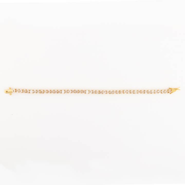 Gold Oakley tennis bracelet featuring a continuous row of round-cut clear crystals.