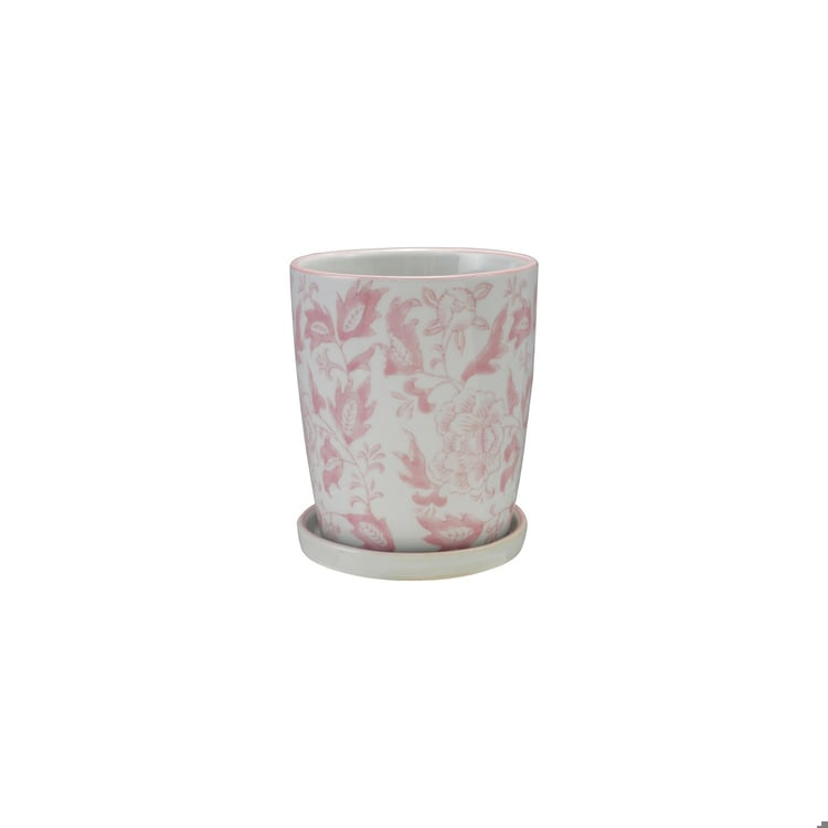 Hand-painted white stoneware planter with pink floral patterns and matching saucer.