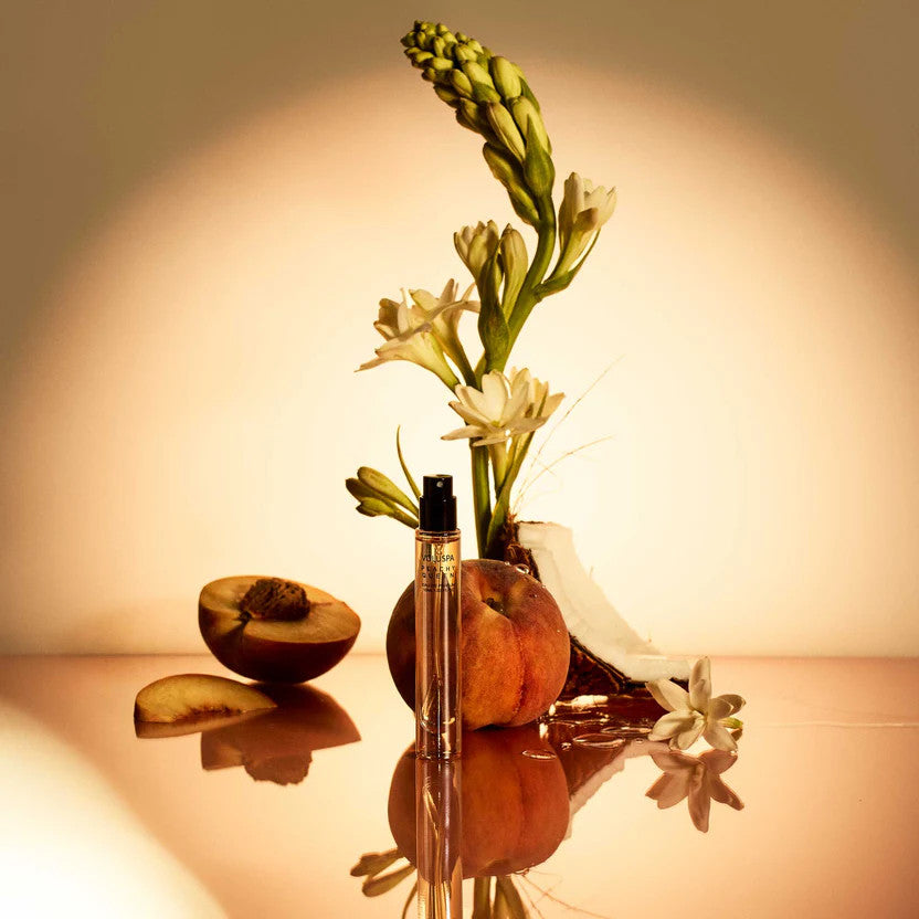 Peachy Queen 10ml Eau De Parfum spray bottle with fresh peach, tuberose flowers, and coconut.