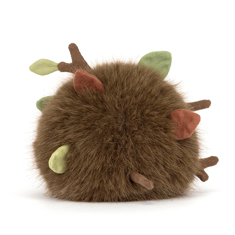 Round brown fuzzy plush toy with small fabric leaves and twigs sticking out.