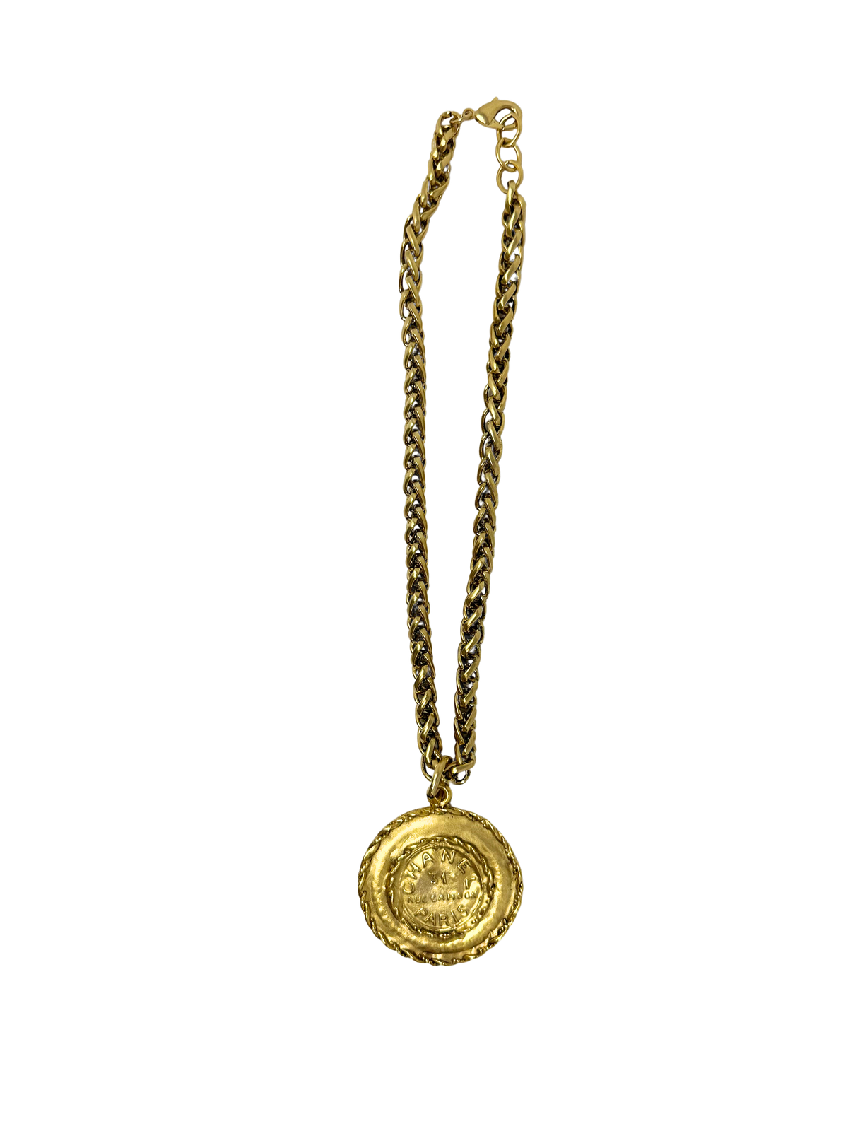 Gold chain necklace featuring a braided coin pendant with embossed designer text.