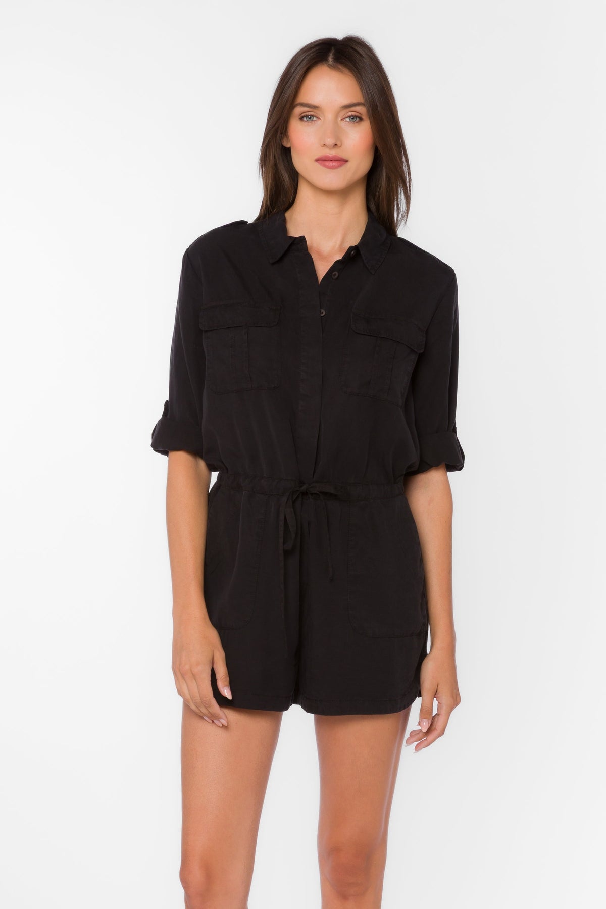 Black TENCEL™ lyocell romper with V-neckline, rolled long sleeves, utility tabs, and porkchop pockets.