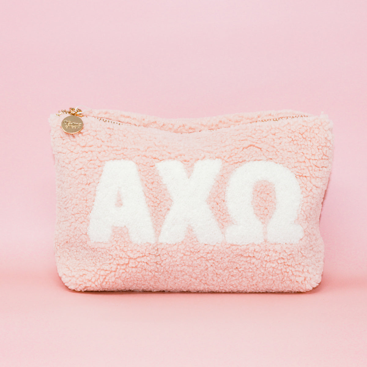 Blush sorority teddy letter pouch with a soft plush texture.