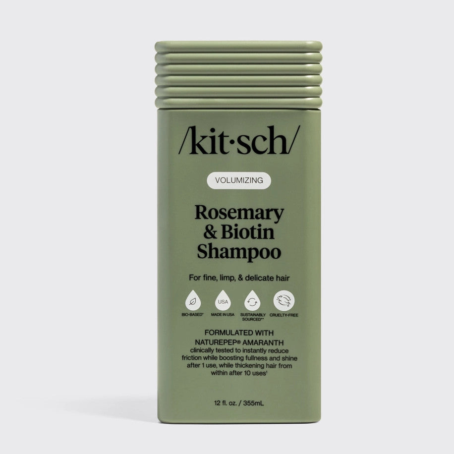 Bottle of Volumizing Rosemary & Biotin Shampoo with a clear pump dispenser and white label.