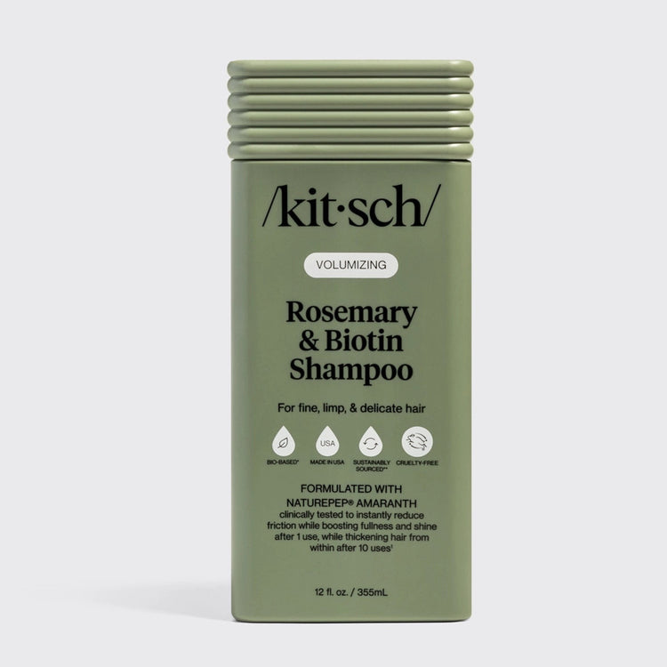 Bottle of Volumizing Rosemary & Biotin Shampoo with a clear pump dispenser and white label.