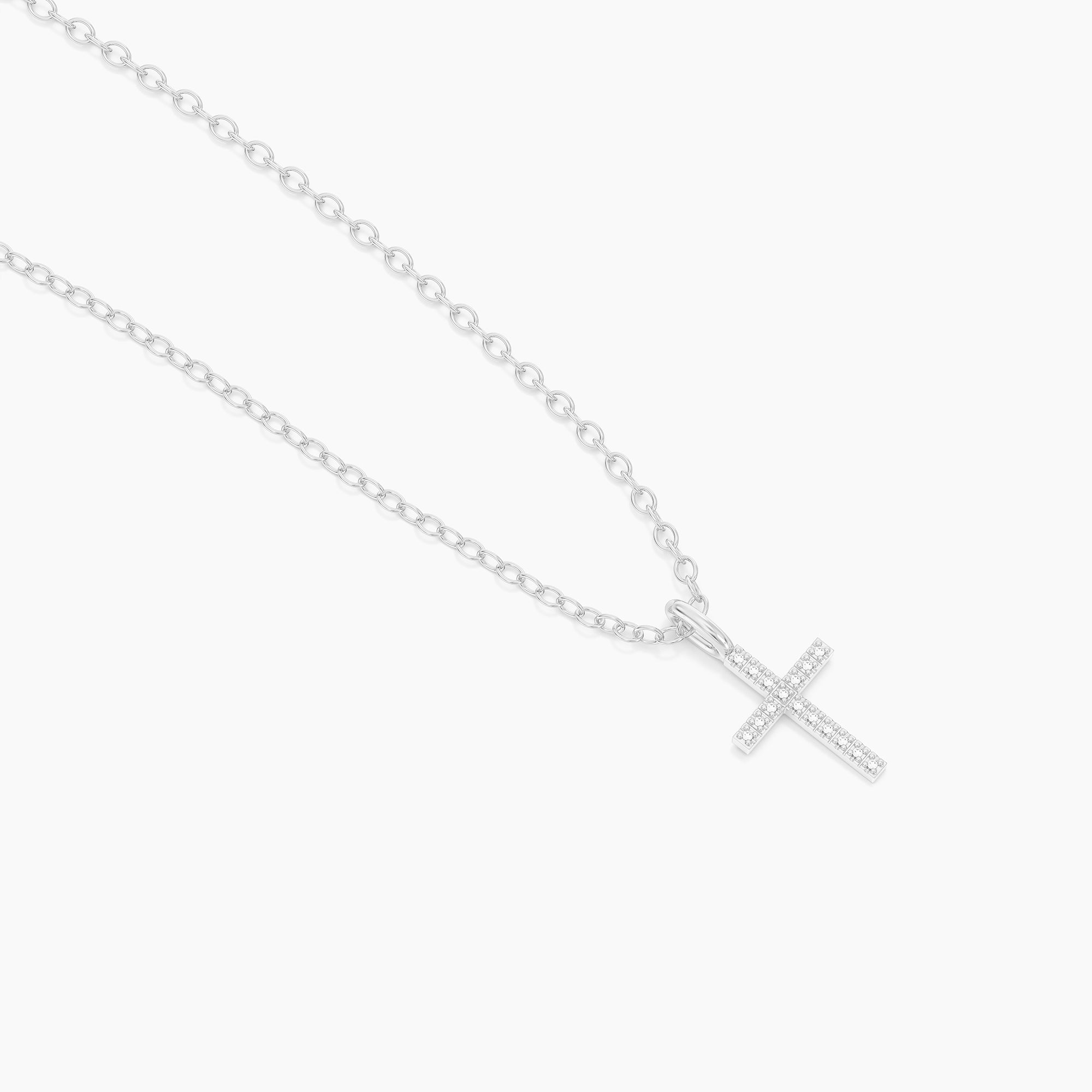 Silver chain necklace featuring a small cross pendant set with sparkling clear stones.