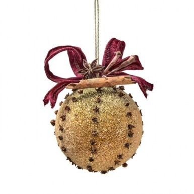 4-inch glittered orange ornament decorated with cloves, a cinnamon stick, star anise, and red bow.