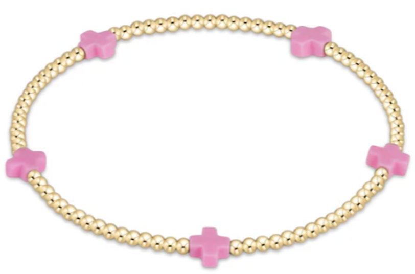 Bright pink bracelet with small gold-patterned beads on elastic cord