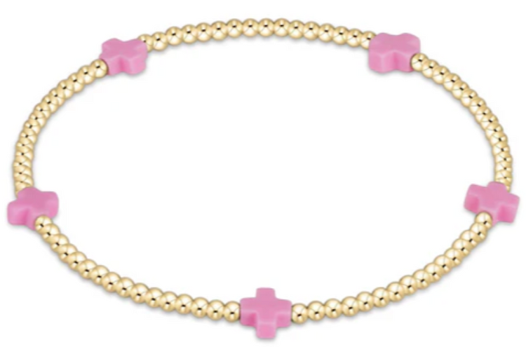 Bright pink bracelet with small gold-patterned beads on elastic cord