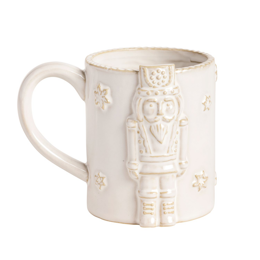 White ceramic Christmas mug with a raised nutcracker icon and snowflake details.