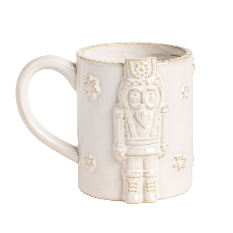 White ceramic Christmas mug with a raised nutcracker icon and snowflake details.