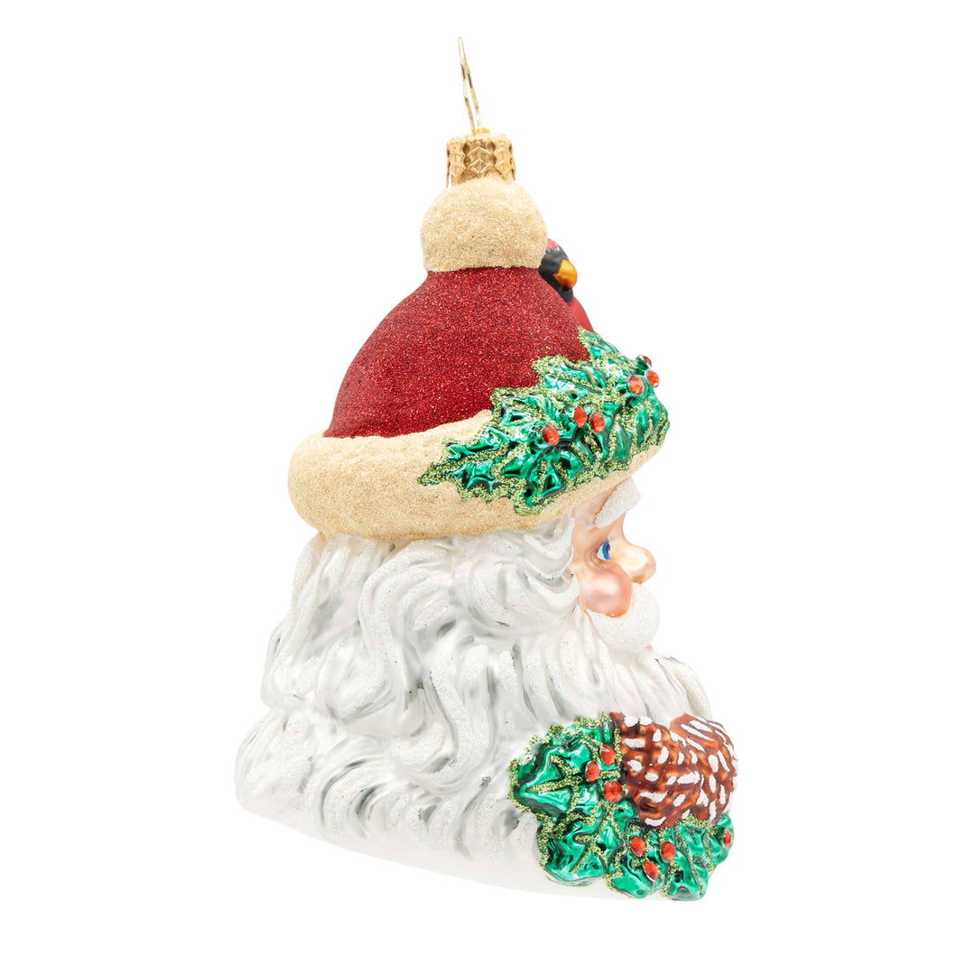 Woodland Wishes Santa glass ornament with holly, pinecones, and a red cardinal on his hat.