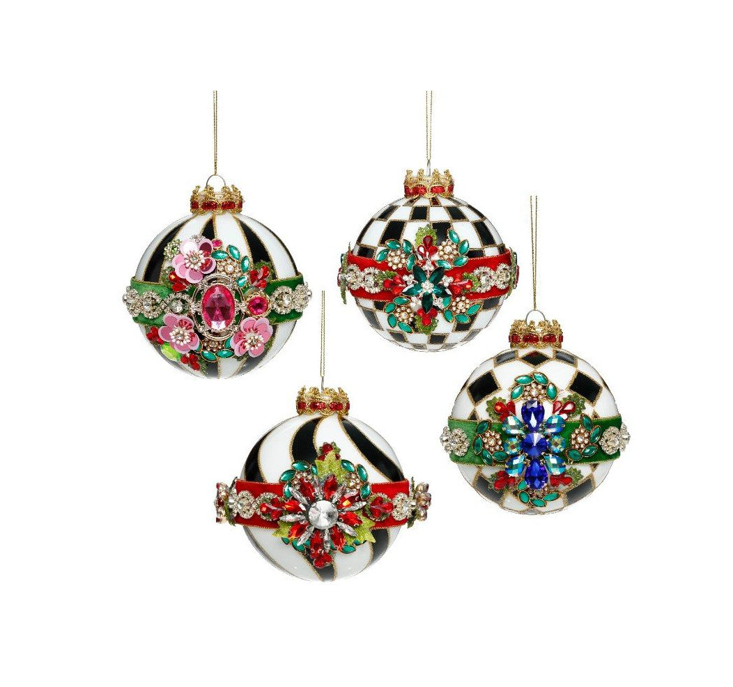 Set of four black and white patterned glass ornaments with colorful jeweled floral embellishments.