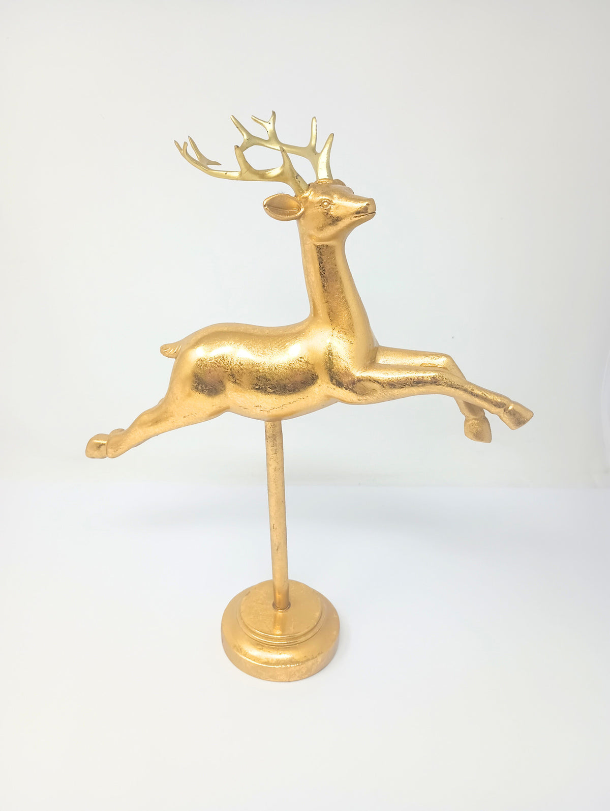 Flying gold reindeer holiday decor with shimmering finish