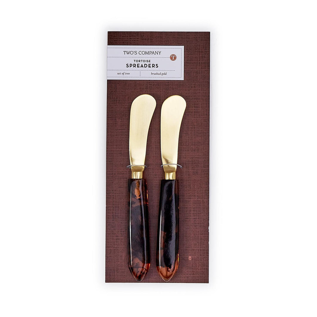 Set of two tortoise swirl resin handle spreaders with brushed gold stainless steel blades.