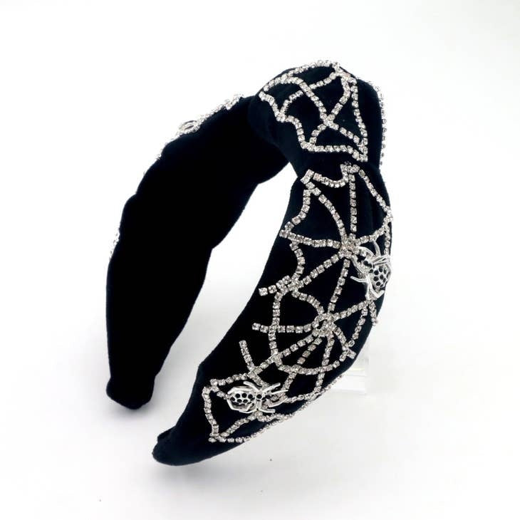 Black velvet headband featuring a crystal spiderweb embellishment