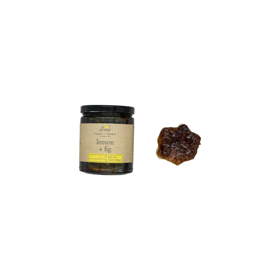 Jar of Lemon + Fig marmalade with a clear lid showing amber-colored preserve.