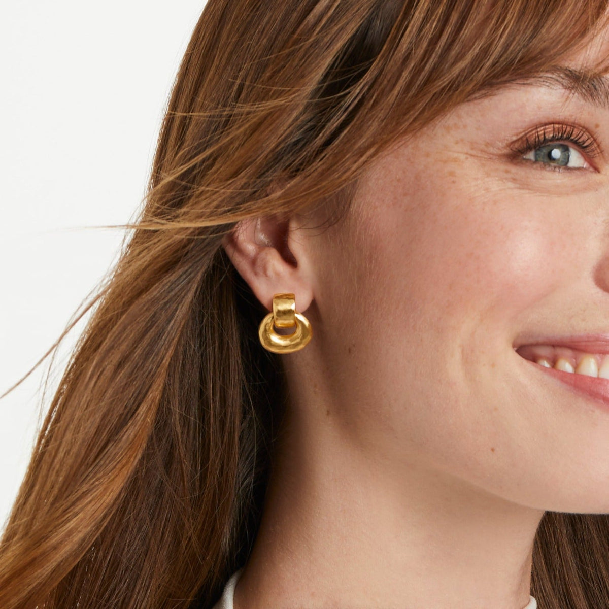Avalon Demi doorknocker earring in gold with a small circular top and curved stem.