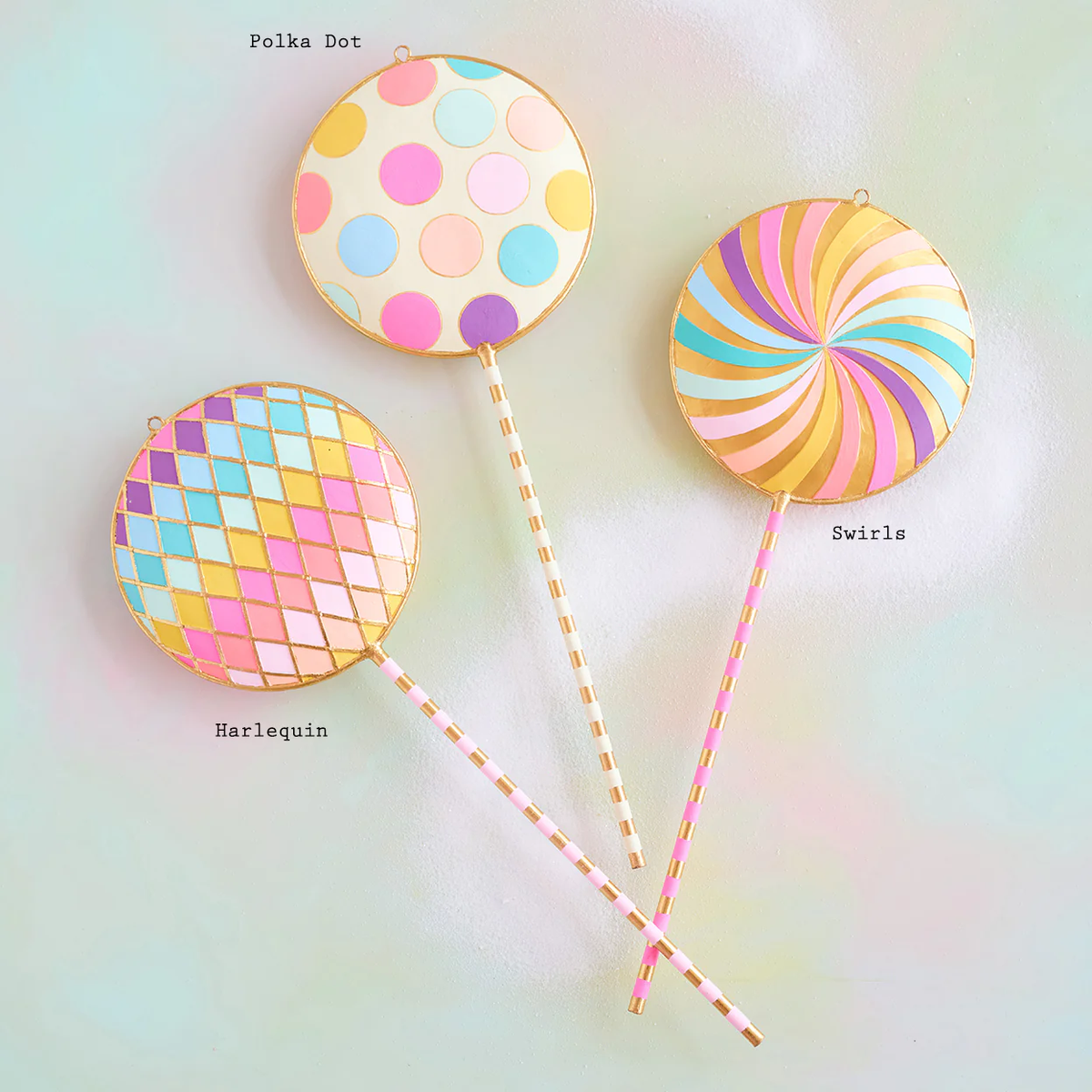 Hand-painted gold leaf lollipop display stand with a circular papermache silhouette.