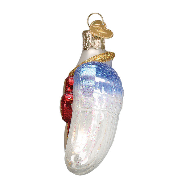 Side view of a glass paw print ornament with blue and white glittered angel wings.