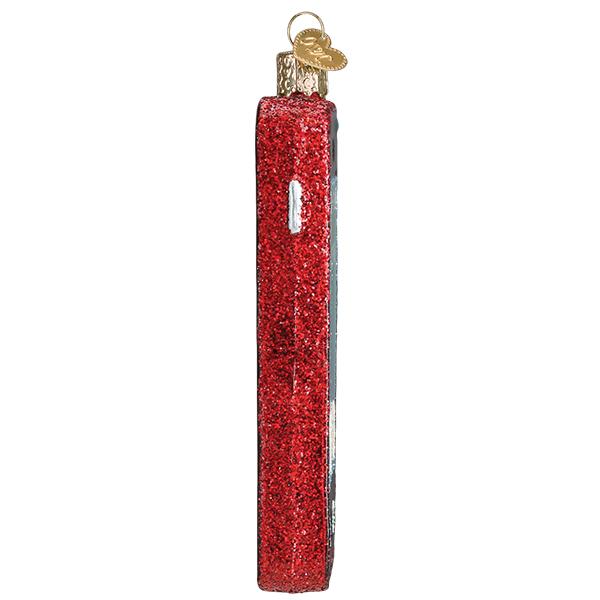 Side view of a red glittery glass smartphone Christmas ornament with a gold heart-shaped charm.