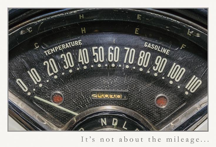 Vintage car dashboard with speedometer, temperature gauge, and fuel gauge. Text reads "It's not about the mileage..."