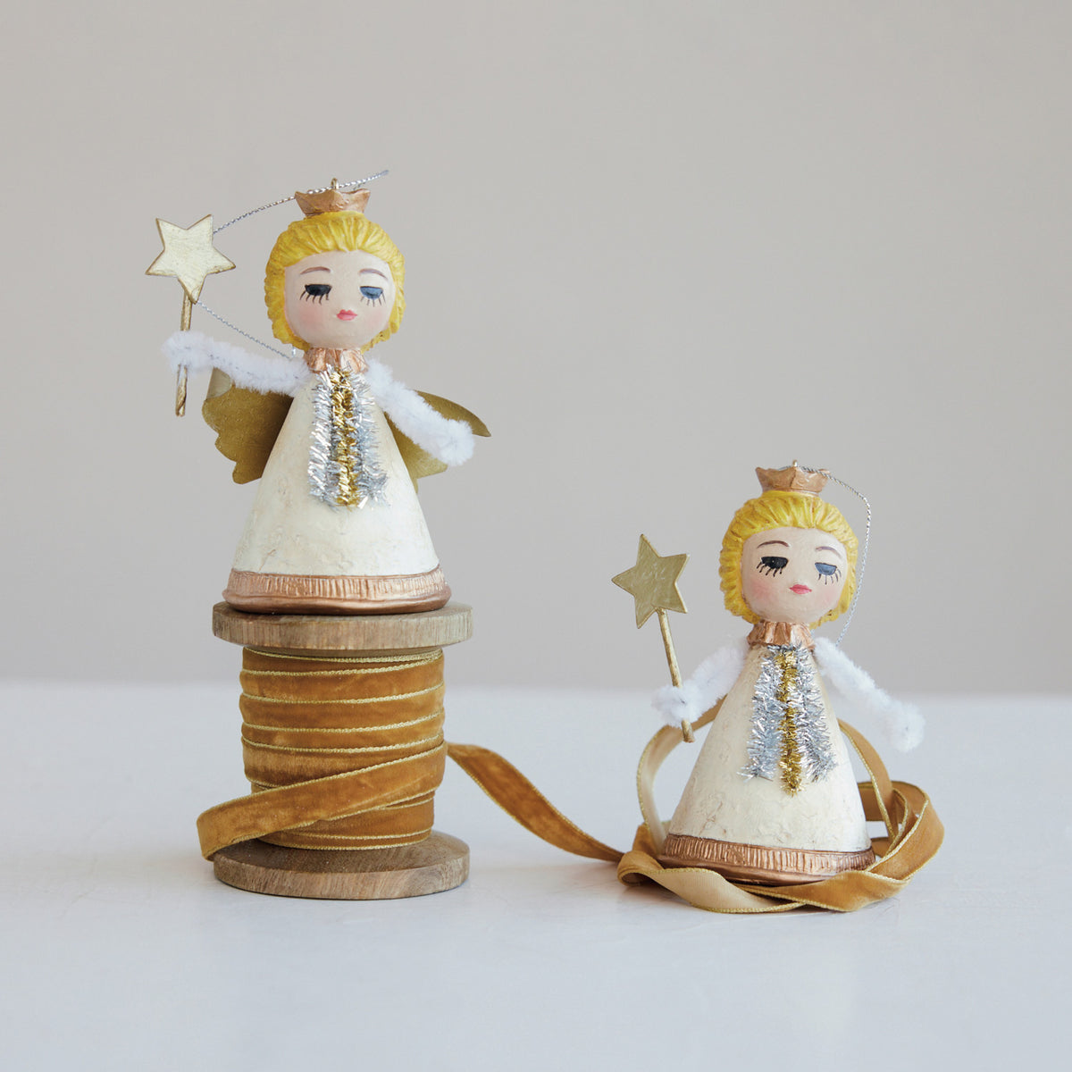 Resin vintage-style angel ornament with golden hair, cream gown, and a glittery star wand.