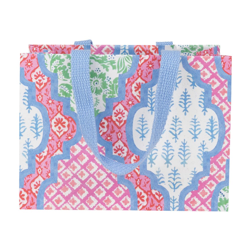 Small gift bag with a colorful floral and geometric pattern and light blue fabric handles.